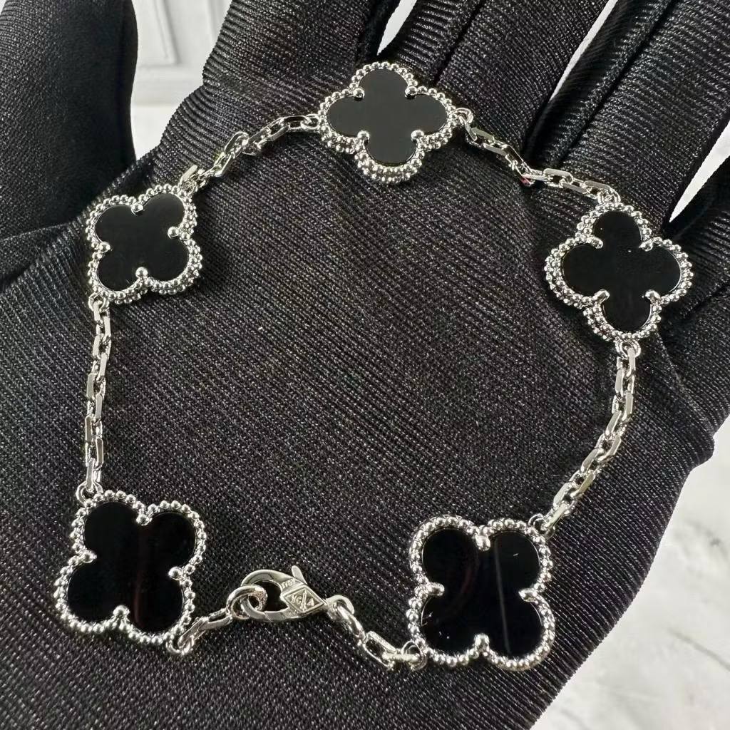 VCA Bracelet - Black onyx clovers on silver, held in hand