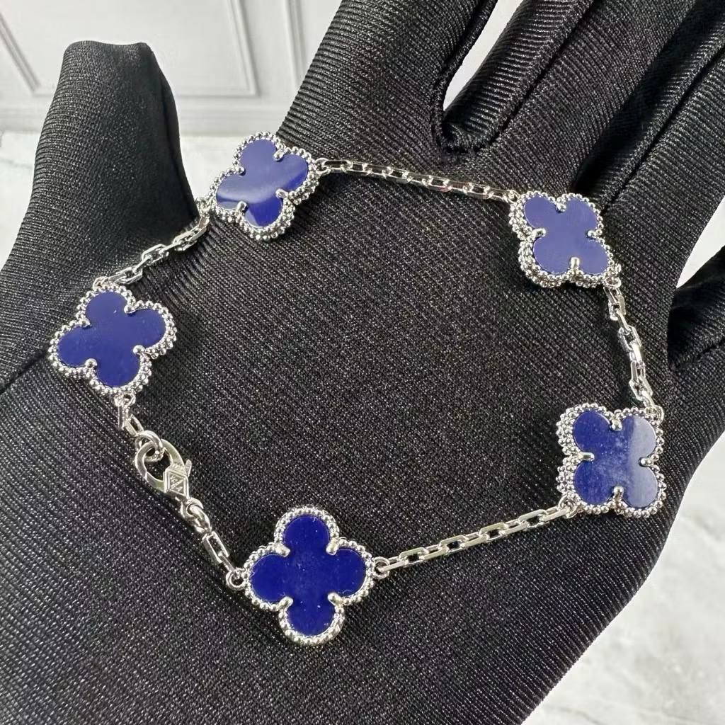 VCA Bracelet - Blue lapis clovers on silver, held in hand