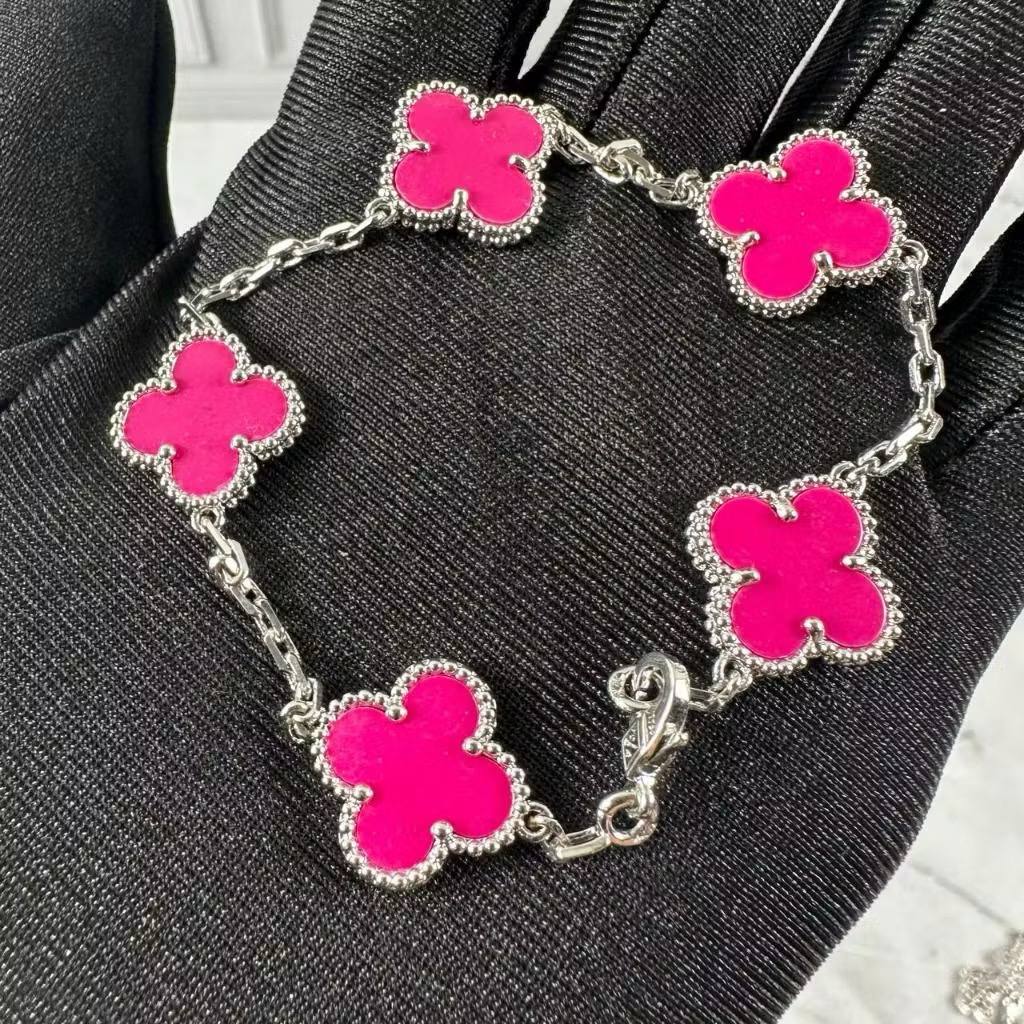 VCA Bracelet - Fuschia pink clovers on silver, held in hand