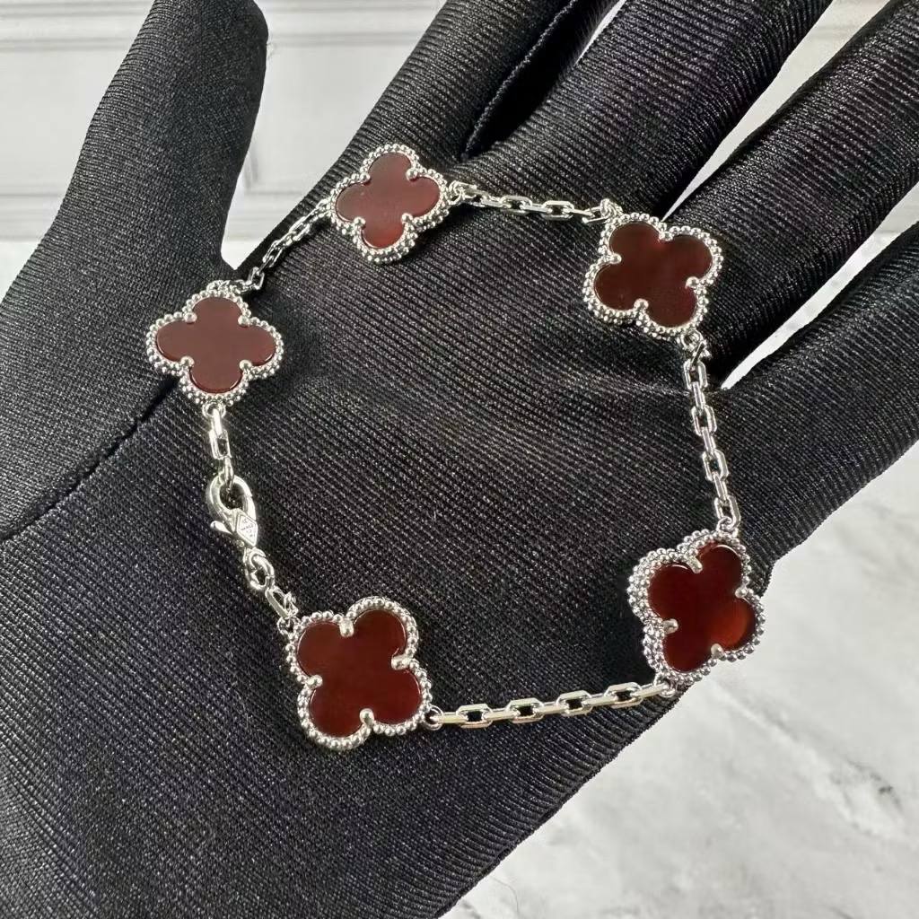 VCA Bracelet - Maroon carnelian clovers on silver, held in hand