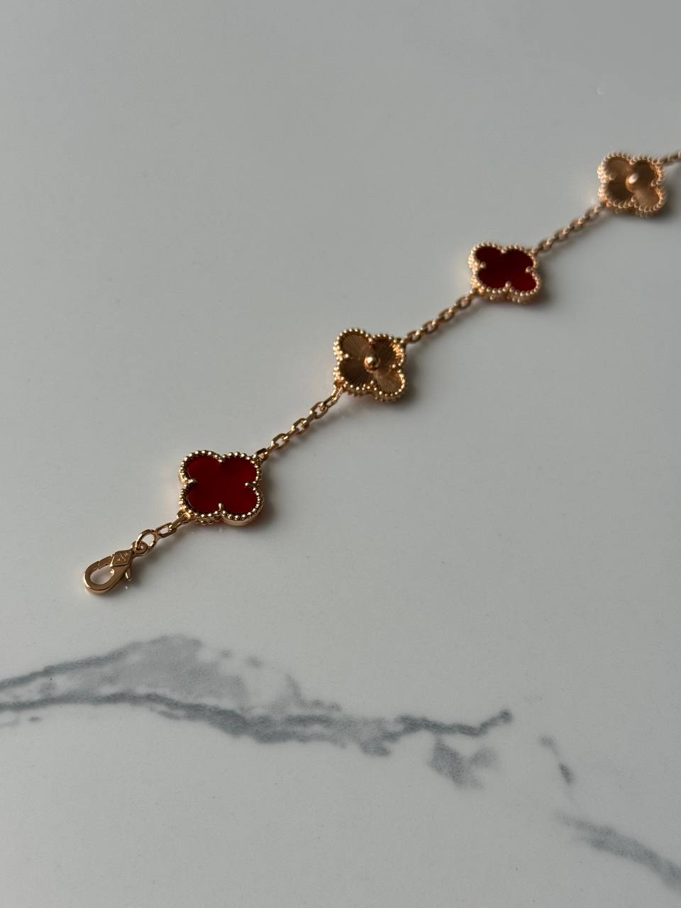 VCA Bracelet - Maroon Gold, close-up on marble
