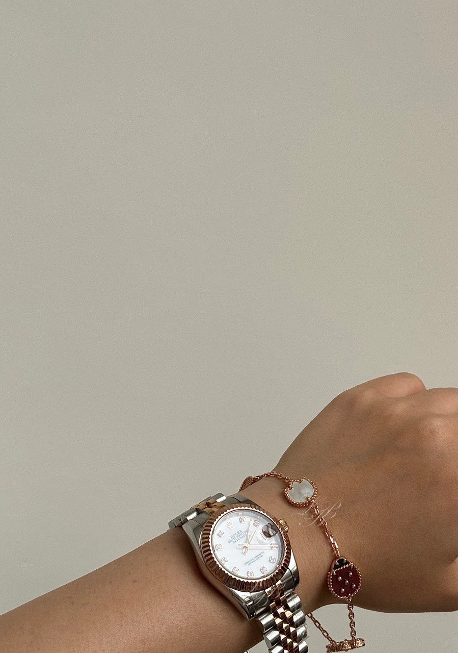 VCA Bracelet - Lady Bug, worn on the wrist with a watch