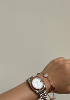 VCA Bracelet - Lady Bug, worn on the wrist with a watch