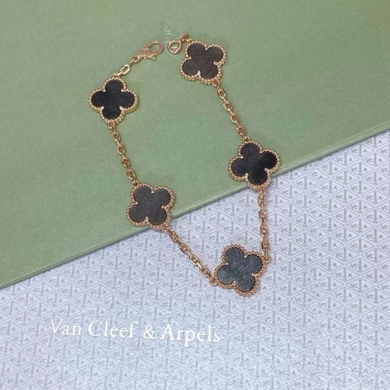 VCA Bracelet - black clovers on gold, flat lay
